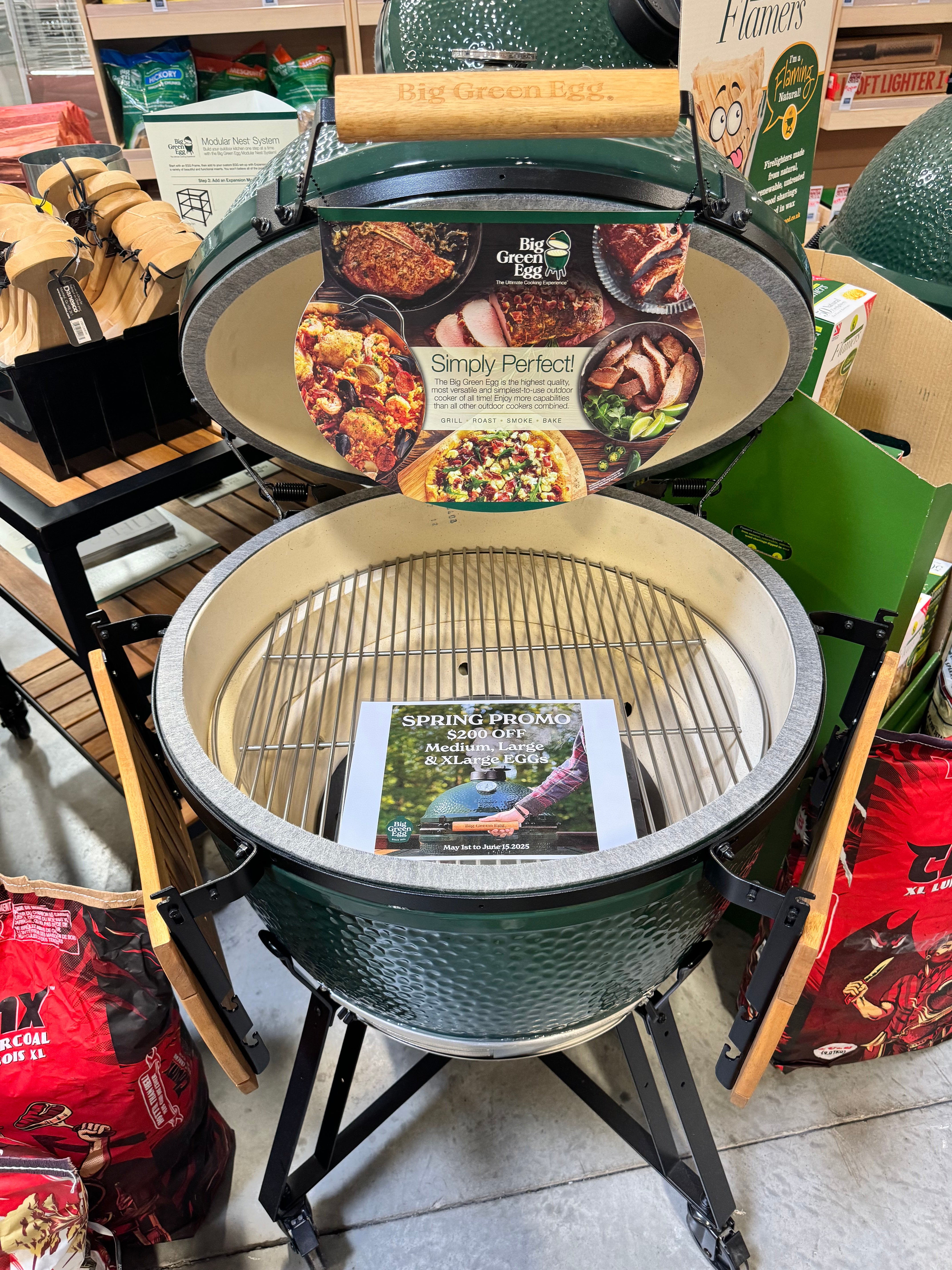 XLarge big green egg inside brama showroom with sale sign on it.